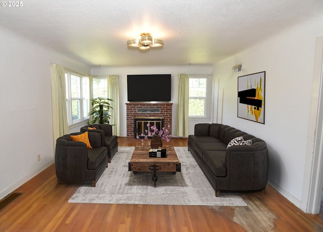 210 Holeman Ave, Eugene, OR 97404 - living room featuring wood finished floors, baseboards, and a fireplace