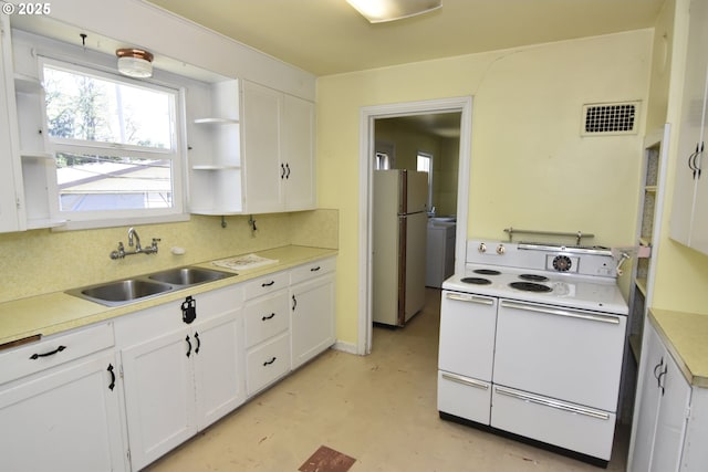 210 Holeman Ave, Eugene, OR 97404 - kitchen featuring white appliances, a sink, white cabinets, and light countertops