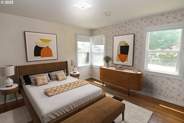 210 Holeman Ave, Eugene, OR 97404 - bedroom with baseboards, multiple windows, wood finished floors, and wallpapered walls