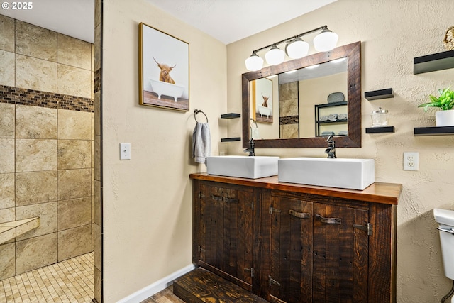 1561 Balboa St, Eugene, OR 97408 - bathroom with double vanity, a tile shower, and a textured wall