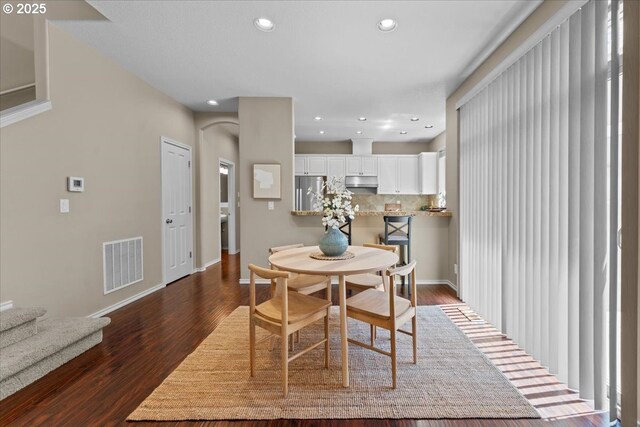 6638 NW Joss Ave, Portland, OR 97229 - dining space with recessed lighting, dark wood-style floors, arched walkways, and baseboards