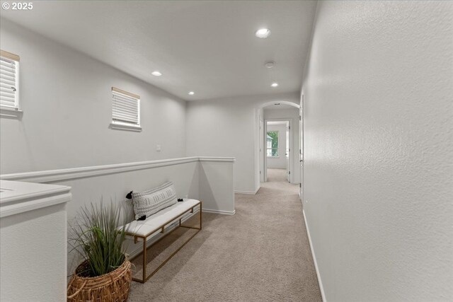 6638 NW Joss Ave, Portland, OR 97229 - hallway featuring light carpet, arched walkways, recessed lighting, and baseboards