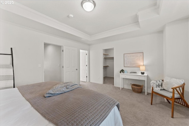 6638 NW Joss Ave, Portland, OR 97229 - carpeted bedroom with crown molding, a raised ceiling, a walk in closet, a closet, and baseboards