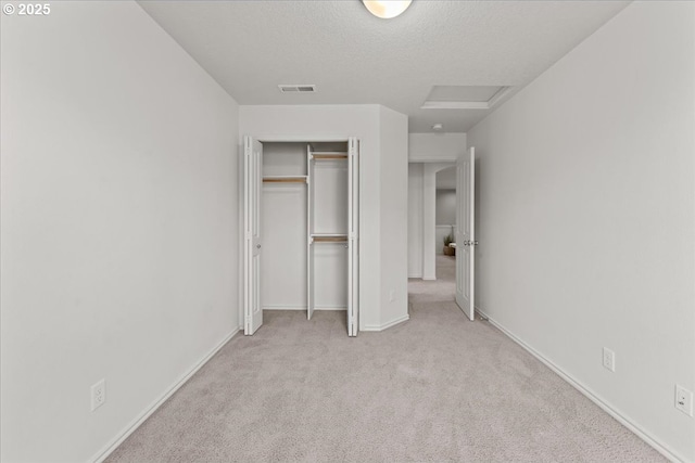 6638 NW Joss Ave, Portland, OR 97229 - unfurnished bedroom with attic access, carpet flooring, a closet, a textured ceiling, and baseboards
