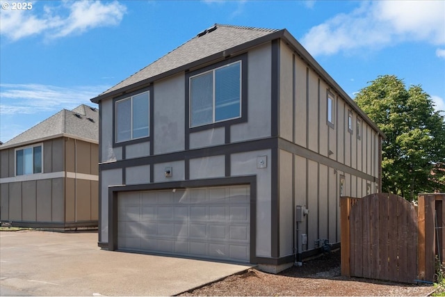 6638 NW Joss Ave, Portland, OR 97229 - view of home's exterior featuring an attached garage, roof with shingles, driveway, and board and batten siding