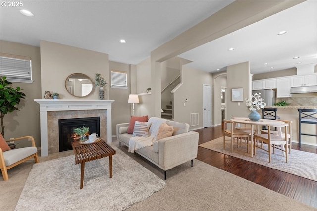 6638 NW Joss Ave, Portland, OR 97229 - living room featuring stairway, a tile fireplace, dark wood-type flooring, recessed lighting, and baseboards