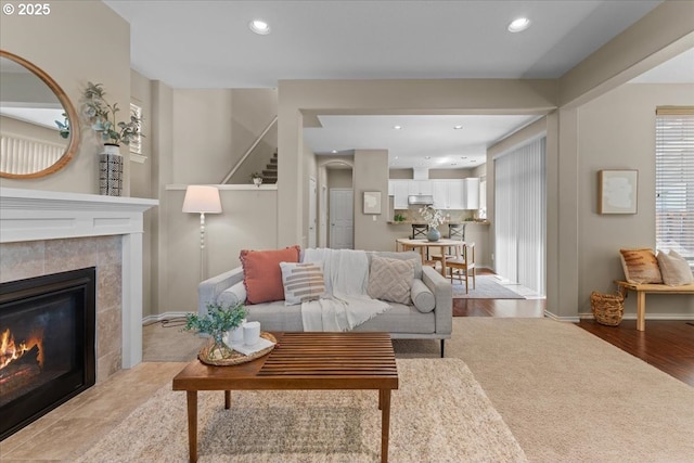 6638 NW Joss Ave, Portland, OR 97229 - living room featuring a tiled fireplace, recessed lighting, baseboards, and light wood finished floors