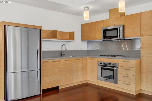 kitchen with light brown cabinetry, open shelves, appliances with stainless steel finishes, a sink, and dark wood finished floors