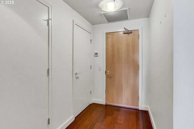doorway to outside with baseboards and dark wood finished floors