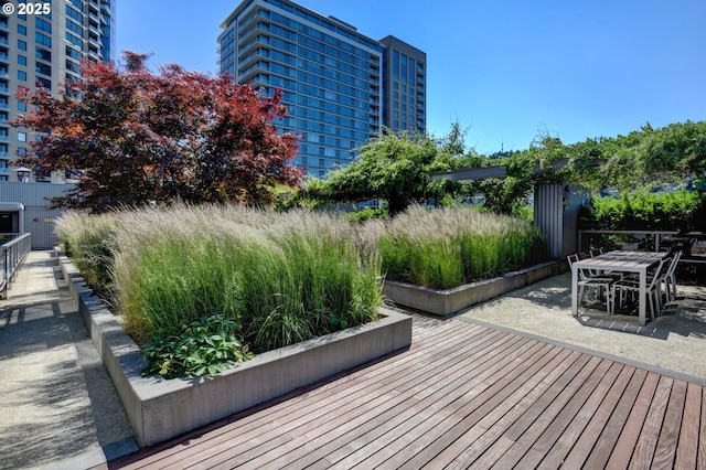 wooden deck with outdoor dining area and a patio area
