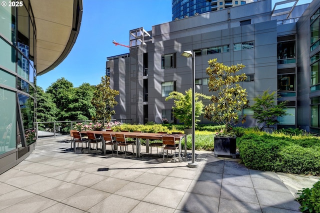 view of property's community featuring a patio and outdoor dining area