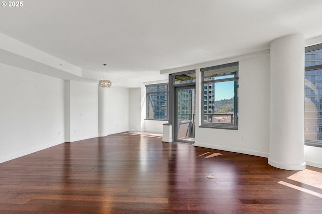 empty room with dark hardwood / wood-style flooring