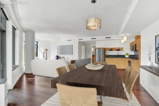 dining area with dark wood-style flooring and visible vents