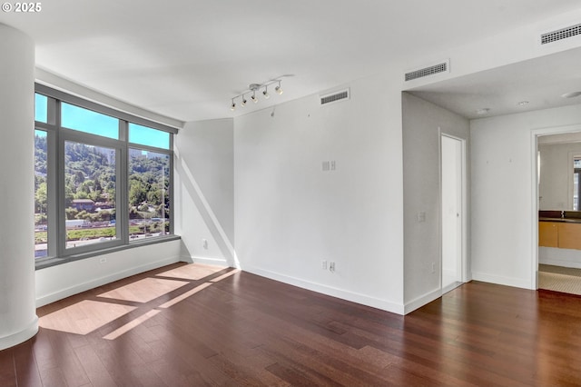 3601 S River Pkwy Unit 1118, Portland, OR 97239 - unfurnished living room with a sink, dark wood-style flooring, and baseboards