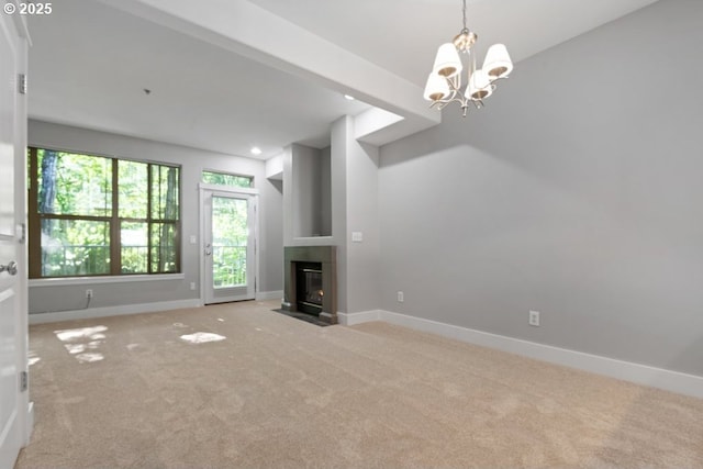 1919 NE 50th Way, Hillsboro, OR 97124 - unfurnished living room with light colored carpet, baseboards, a chandelier, and a fireplace with flush hearth