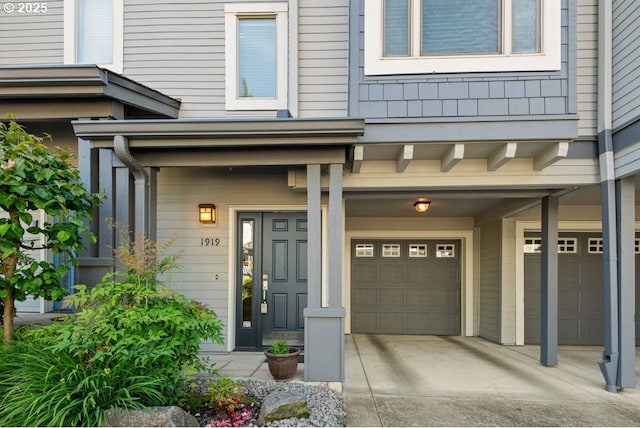1919 NE 50th Way, Hillsboro, OR 97124 - view of exterior entry featuring an attached garage and concrete driveway