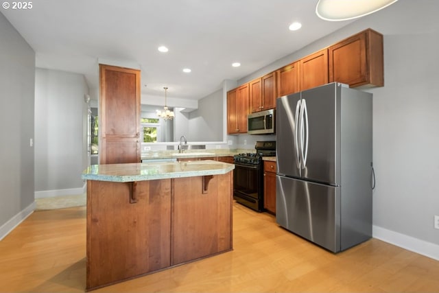 1919 NE 50th Way, Hillsboro, OR 97124 - kitchen featuring stainless steel appliances, a kitchen bar, light wood finished floors, recessed lighting, and baseboards