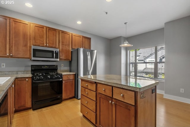 1919 NE 50th Way, Hillsboro, OR 97124 - kitchen featuring stainless steel appliances, light wood-type flooring, brown cabinetry, recessed lighting, and a center island