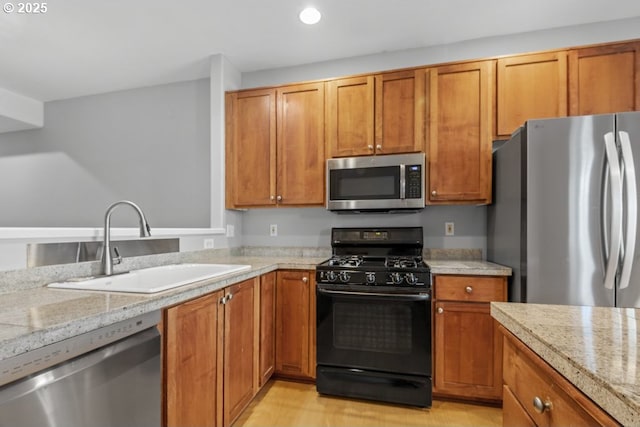 1919 NE 50th Way, Hillsboro, OR 97124 - kitchen with appliances with stainless steel finishes, a sink, brown cabinets, light wood-style flooring, and recessed lighting