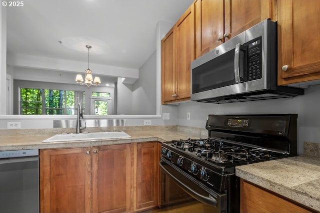 1919 NE 50th Way, Hillsboro, OR 97124 - kitchen featuring appliances with stainless steel finishes, a sink, a chandelier, light countertops, and brown cabinetry
