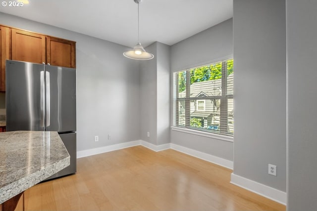 1919 NE 50th Way, Hillsboro, OR 97124 - unfurnished dining area featuring light wood-type flooring and baseboards
