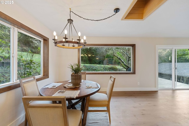 dining space featuring a chandelier and light wood-type flooring