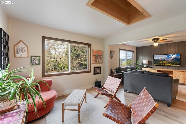 living room with ceiling fan and light wood-type flooring