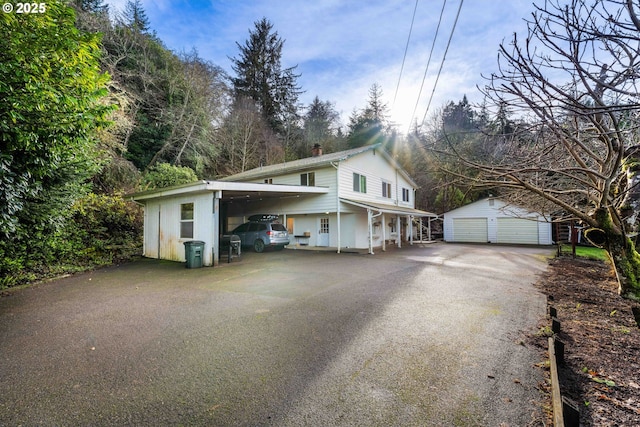 view of property exterior featuring an outbuilding and a carport