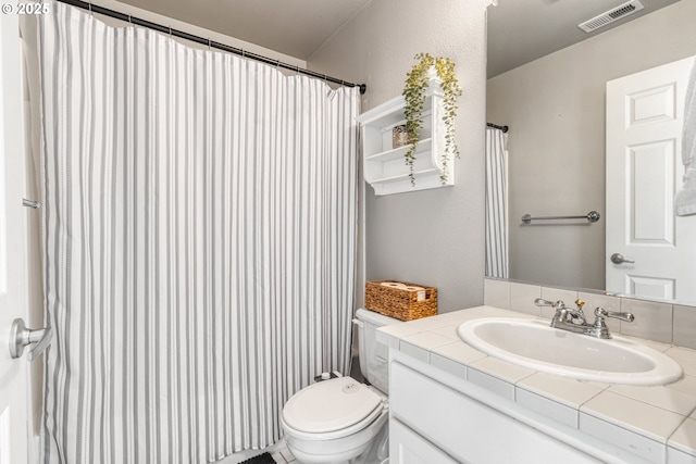 bathroom with toilet and vanity