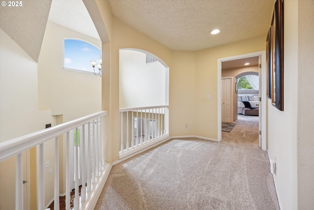 19580 SW 56th Ct, Tualatin, OR 97062 - hall with carpet flooring, arched walkways, recessed lighting, and a textured ceiling