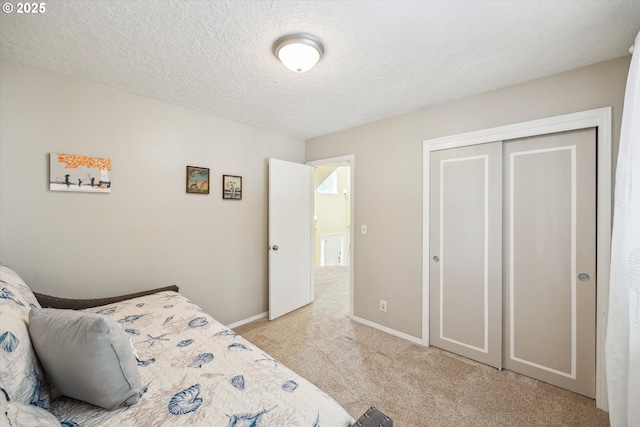 19580 SW 56th Ct, Tualatin, OR 97062 - bedroom featuring light colored carpet, a textured ceiling, baseboards, and a closet