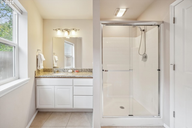 19580 SW 56th Ct, Tualatin, OR 97062 - bathroom featuring a stall shower, vanity, tile patterned flooring, and baseboards