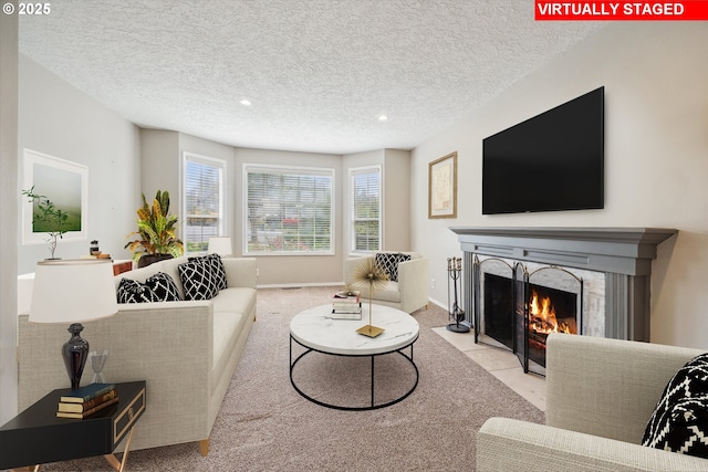 19580 SW 56th Ct, Tualatin, OR 97062 - carpeted living area featuring a fireplace with flush hearth, recessed lighting, a textured ceiling, and baseboards
