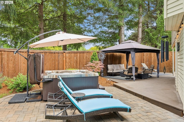 19580 SW 56th Ct, Tualatin, OR 97062 - fenced backyard featuring outdoor lounge area, a hot tub, a patio, and a wooden deck