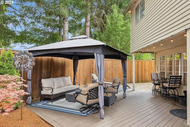 19580 SW 56th Ct, Tualatin, OR 97062 - wooden terrace featuring outdoor lounge area, a gazebo, a fenced backyard, and outdoor dining area