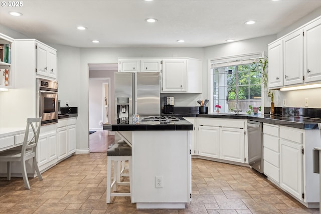 19580 SW 56th Ct, Tualatin, OR 97062 - kitchen with stainless steel appliances, light stone finish flooring, a sink, white cabinets, and recessed lighting