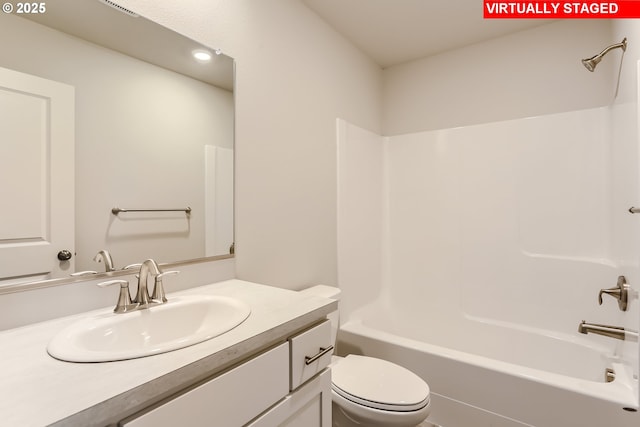 bathroom with shower / bathtub combination, toilet, and vanity