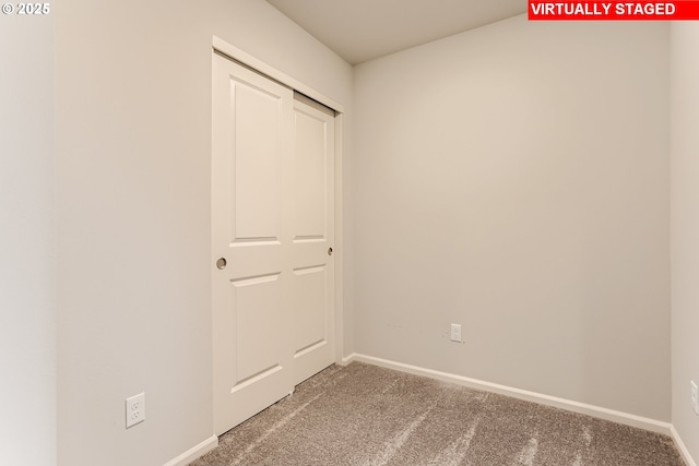 unfurnished bedroom with carpet flooring and baseboards