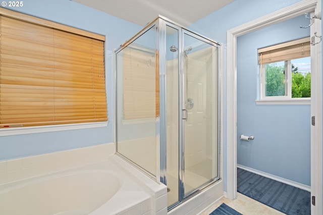 23804 SW Golden Pond Ter, Sherwood, OR 97140 - bathroom featuring a shower stall, a garden tub, and tile patterned floors