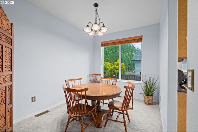 23804 SW Golden Pond Ter, Sherwood, OR 97140 - dining space with light colored carpet, baseboards, and a chandelier