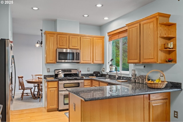 23804 SW Golden Pond Ter, Sherwood, OR 97140 - kitchen with stainless steel appliances, a sink, a peninsula, recessed lighting, and dark stone counters
