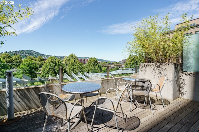 wooden terrace with outdoor dining area