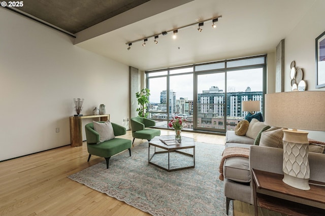 1410 NW Kearney St Unit 1019, Portland, OR 97209 - living area with rail lighting, a view of city, a wall of windows, and wood finished floors