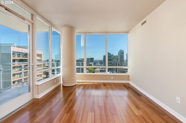 1500 SW 11th Ave Unit 1703, Portland, OR 97201 - empty room with baseboards, a view of city, visible vents, and wood finished floors
