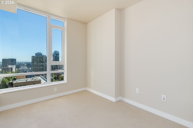 1500 SW 11th Ave Unit 1703, Portland, OR 97201 - carpeted empty room featuring baseboards and a view of city