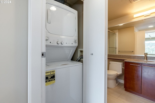 1500 SW 11th Ave Unit 1703, Portland, OR 97201 - laundry area with laundry area, light tile patterned flooring, stacked washer / drying machine, and a sink