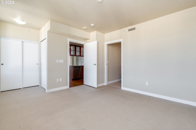 1500 SW 11th Ave Unit 1703, Portland, OR 97201 - unfurnished bedroom with visible vents, a textured ceiling, baseboards, and carpet floors