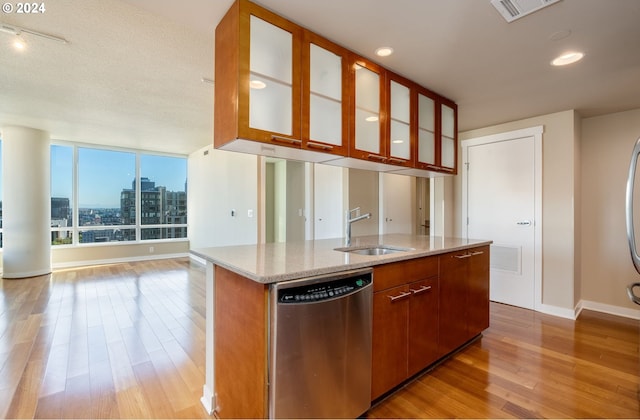 1500 SW 11th Ave Unit 1703, Portland, OR 97201 - kitchen with visible vents, open floor plan, dishwasher, light wood-style flooring, and a sink