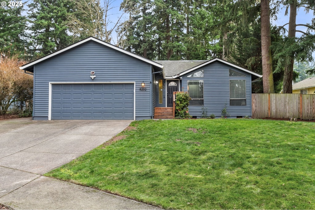 ranch-style home with a garage and a front lawn