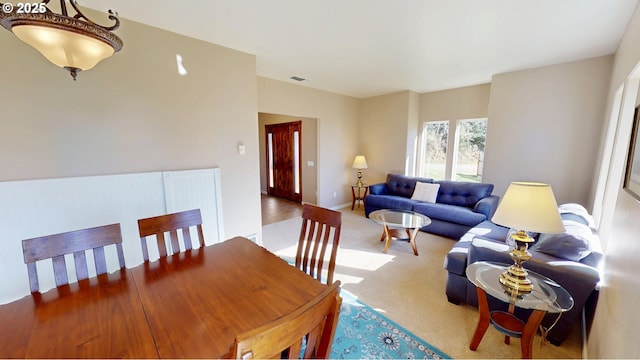 dining room with carpet flooring, baseboards, and visible vents